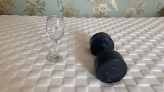 A wine glass and a dumbbell on the Levitex Gravity Defying Mattress