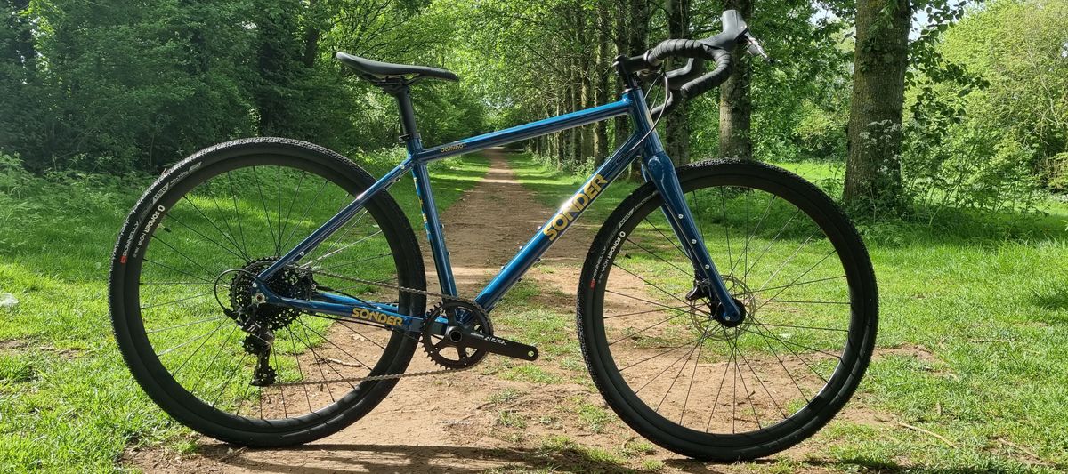 A blue Sonder Camino gravel bike on some singletrack