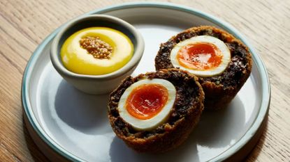 an image of the homemade scotch egg at Willett's in Chelsea, complete with a ramekin of mustard