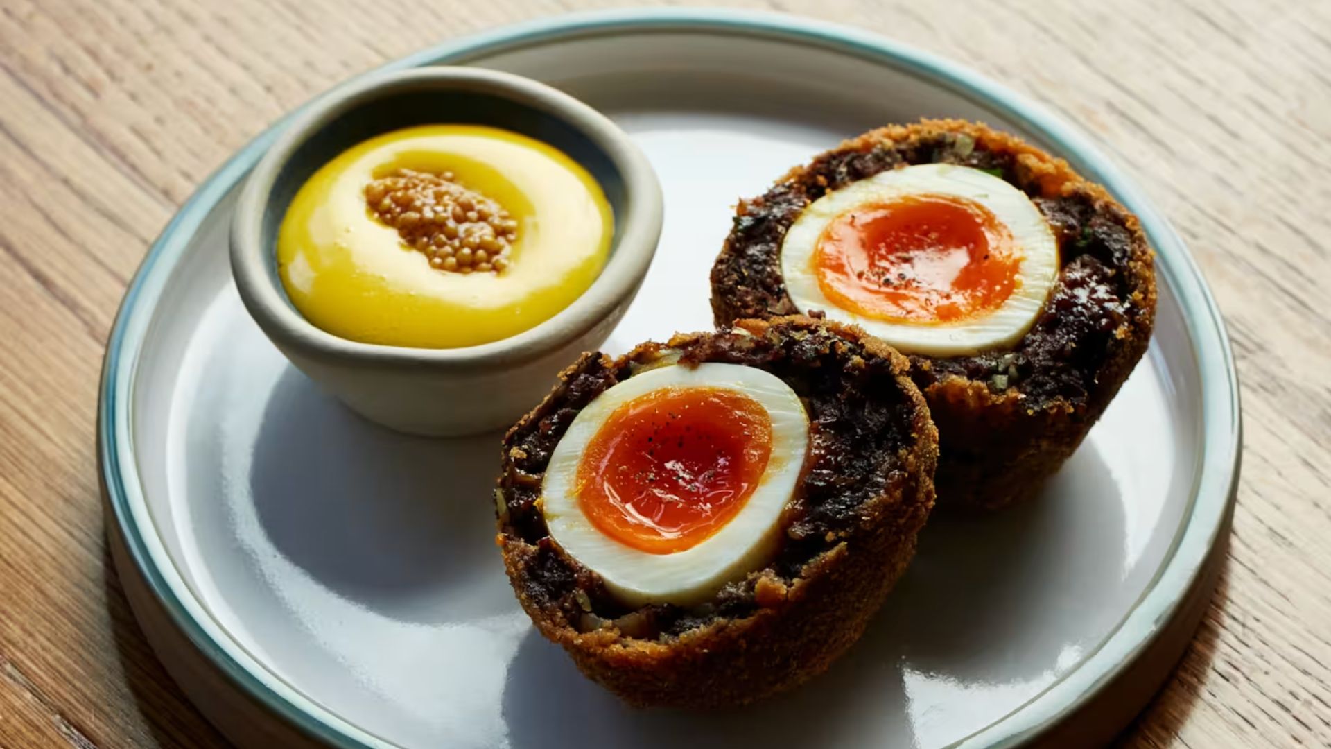 an image of the homemade scotch egg at Willett's in Chelsea, complete with a ramekin of mustard