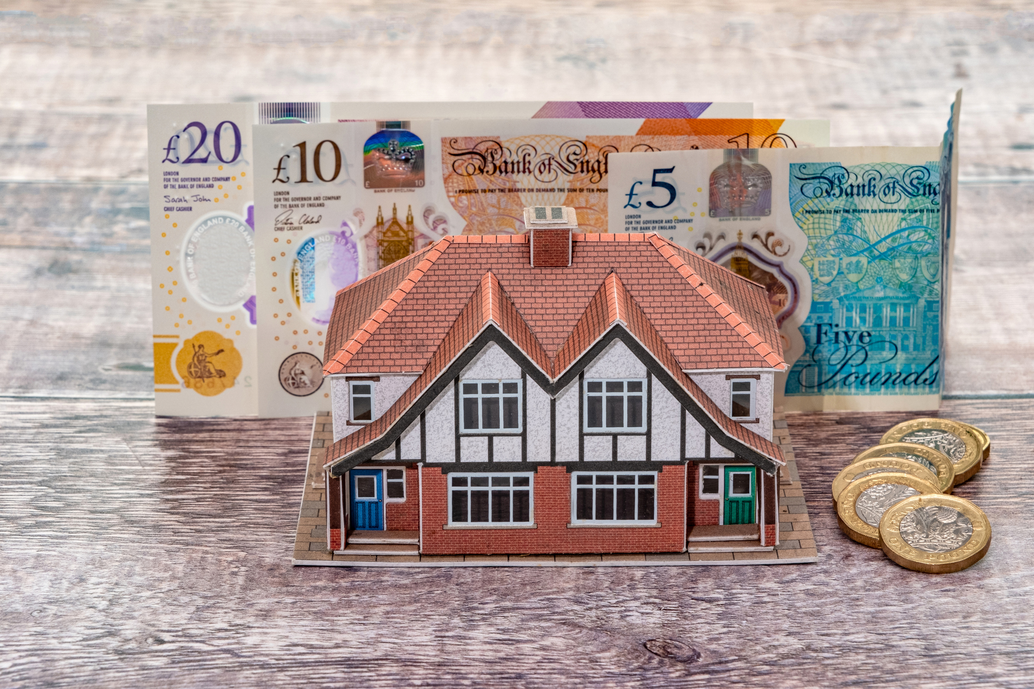 Property in front of money to show the cash that can be released from downsizing