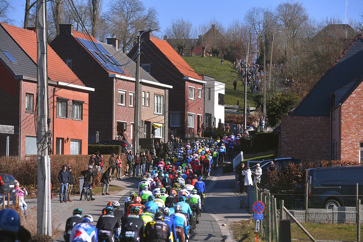 The peloton picks their way up a climb