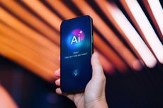A hand holding a phone with AI on the screen 