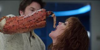 Jason Bateman feeding Melissa McCarthy raw chicken in Thunder Force.