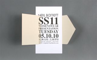 Alternative view of Neil Barrett's black and white invitation featuring an envelope pictured against a grey background. The envelope is open revealing the details of the event