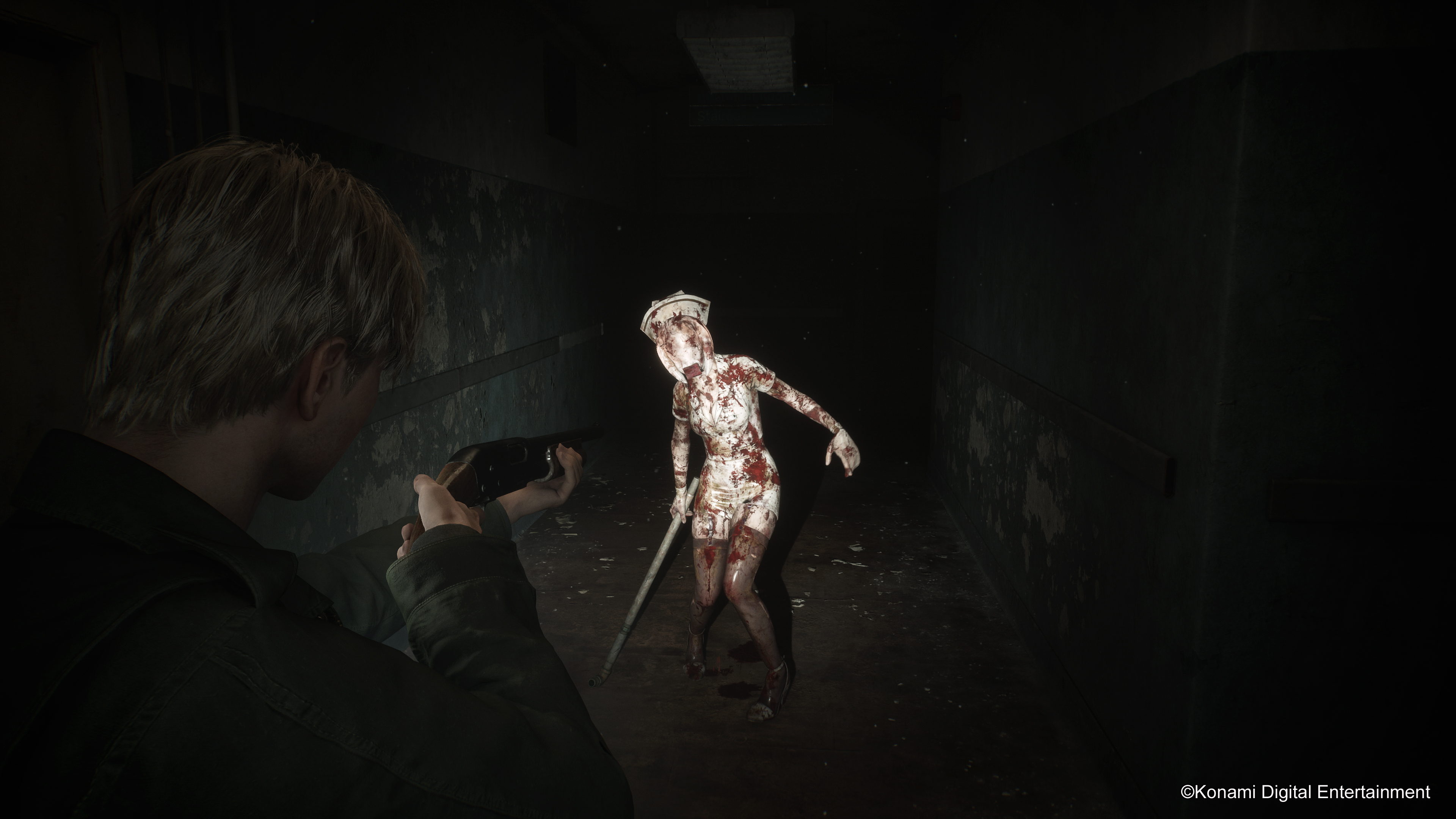 James Sunderland aims a shotgun at a bubble head nurse in the hospital in Silent Hill 2 remake