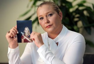 Virginia Roberts holds a photo of herself at age 16, when she says Palm Beach multimillionaire Jeffrey Epstein began abusing her sexually.