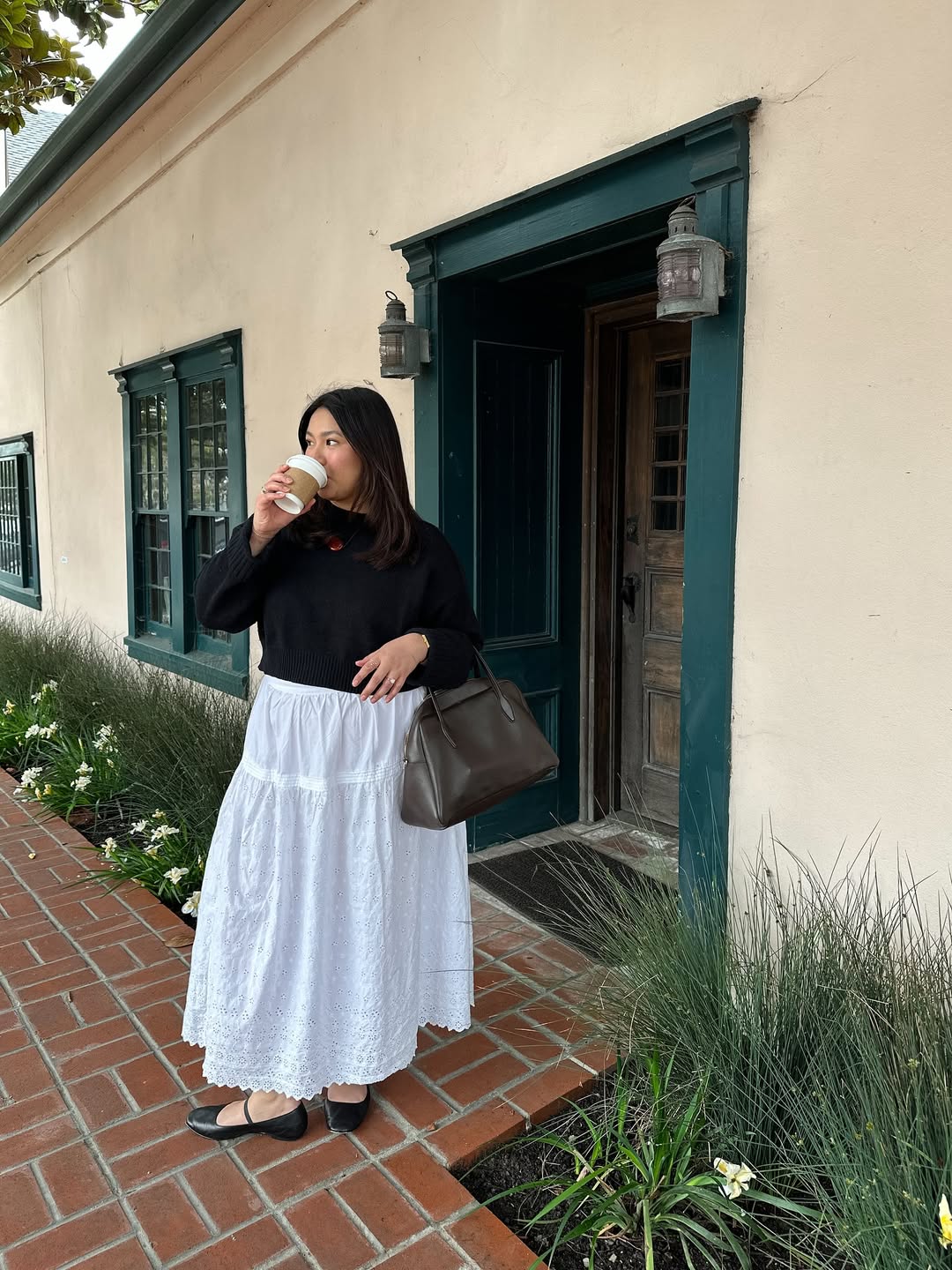 Marina in a white skirt and black jumper