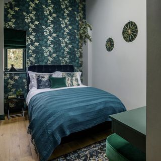 bedroom with grey and green designed wall and green bed