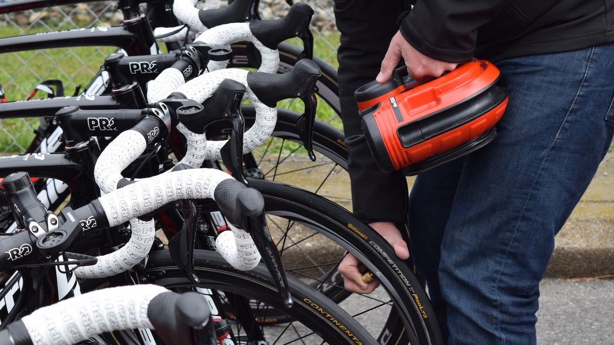 The team's tyre pressures are checked with an electronic pump and gauge ahead of the stage start