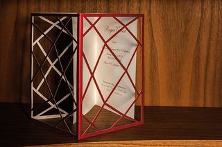 a metallic red overlay that unfolded to reveal a traditional scripted invitation