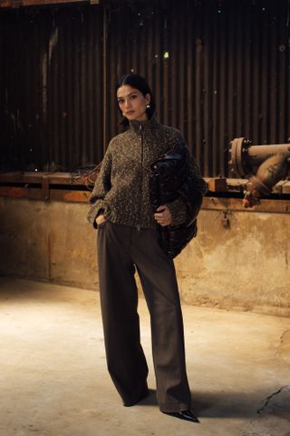 woman wearing sweater, trousers, and heels