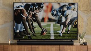 TV with Sonos Arc underneath image of football players