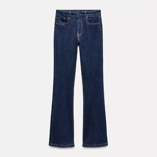 Cut out of dark denim Zara bootcut jeans on a white background