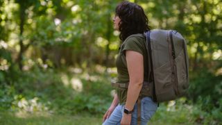 The Peak Design Travel 2-in-1 Backpack outdoors used by a photographer