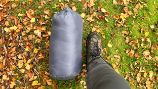 The Big Agnes Anthracite 20° sleeping bag in stuff sack size comparison with foot