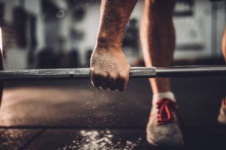 Photo of someone weight lifting in a gym