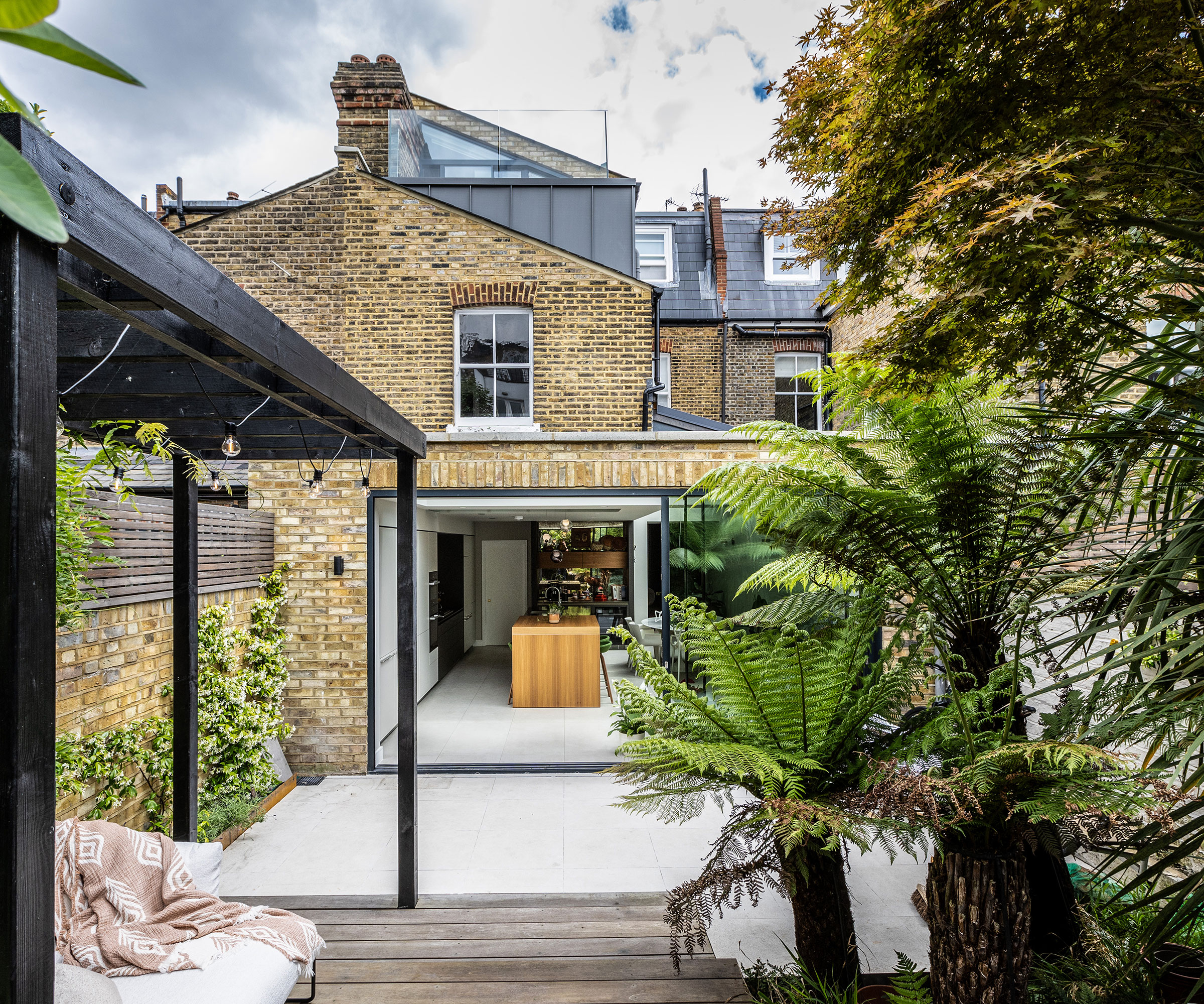 London brick terraced house with flat roof kitchen extension and roof extension