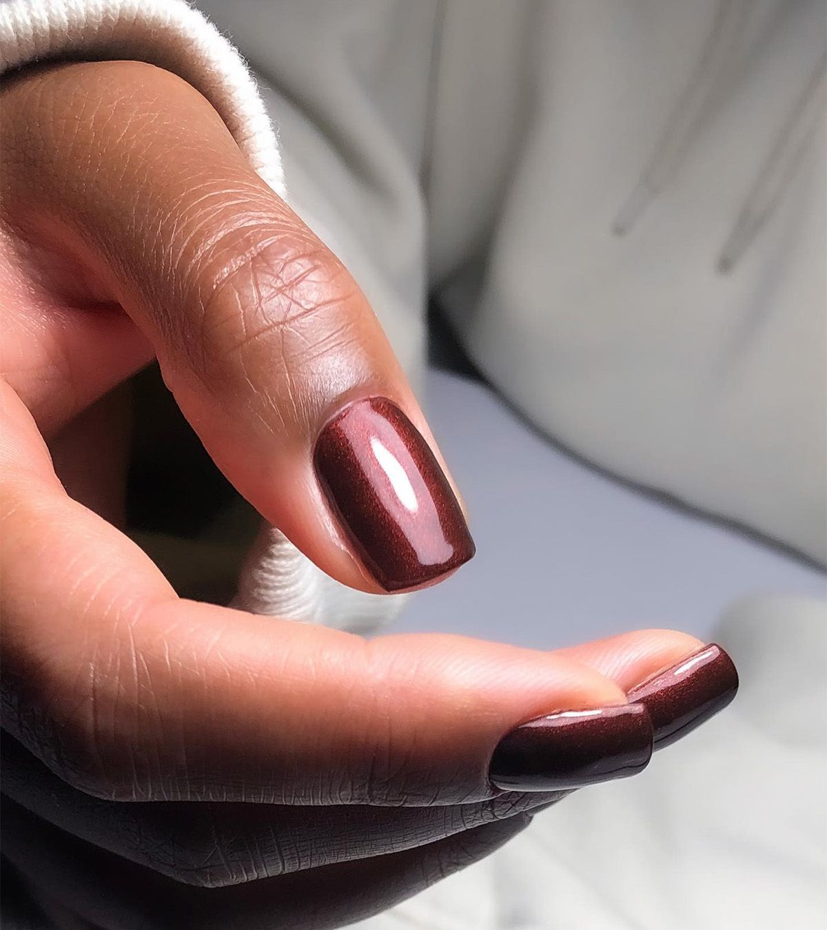 A shimmering, chocolate brown manicure by Julia Diogo