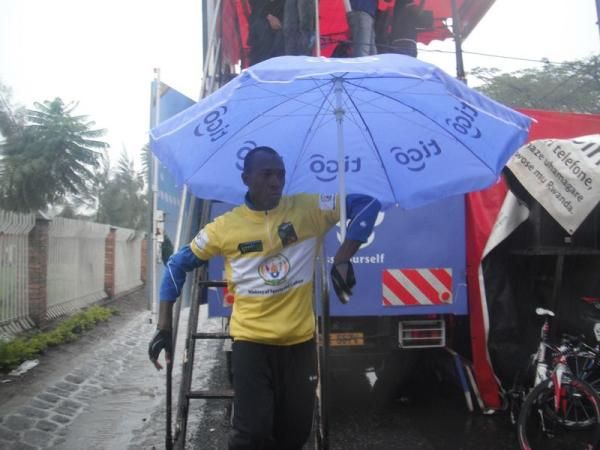 New race leader Adrien Niyonshuti (Rwanda) tries to stay dry after the podium ceremony.