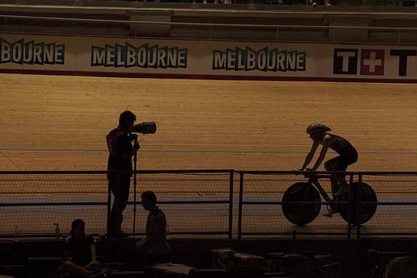 A photographer and a rider during a lull in proceedings on the final day of racing in Melbourne.