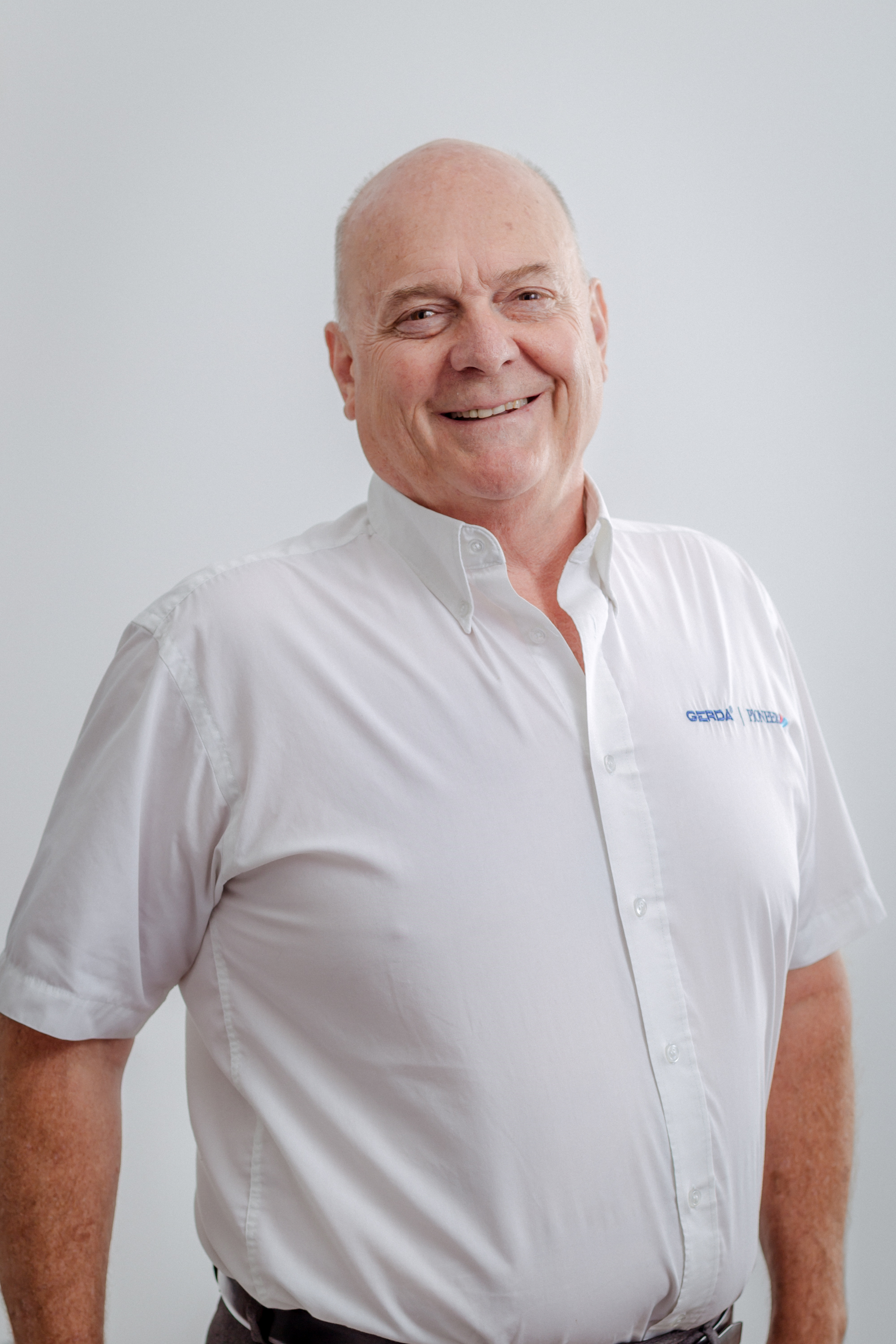 Professional posed photo of expert in white shirt against a white background