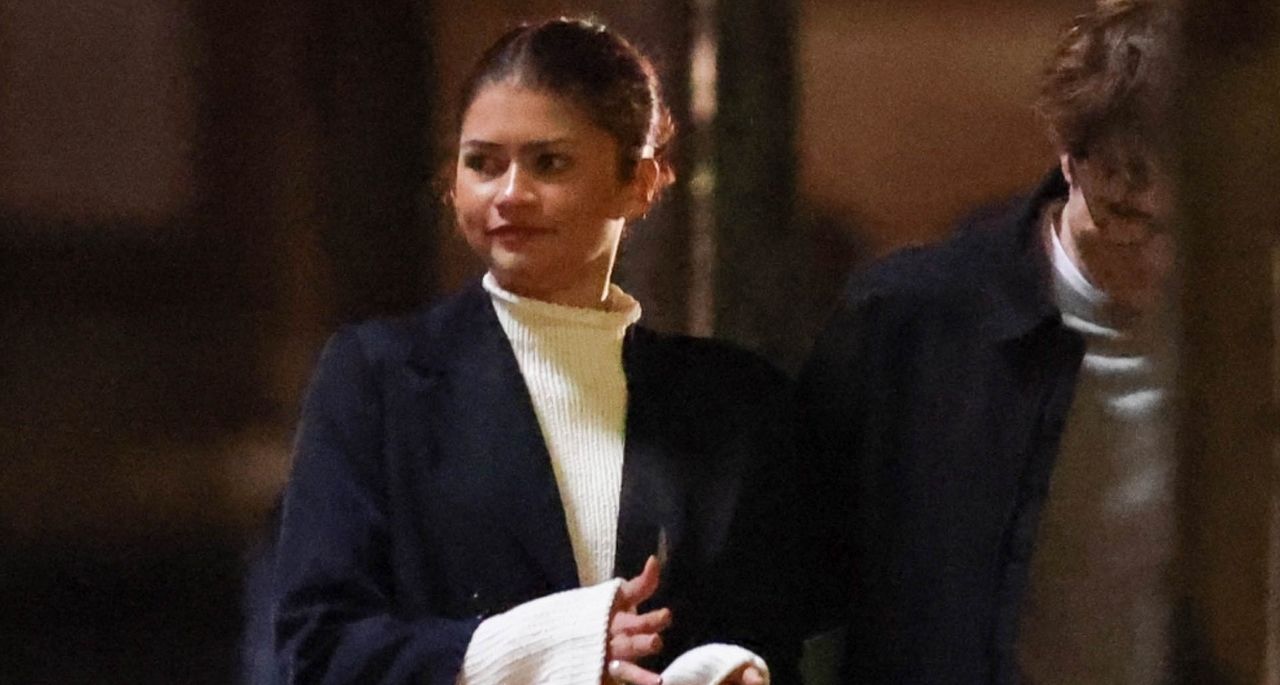 Zendaya wears a rollneck cream sweater with a black coat on the set of The Drama with Robert Pattinson