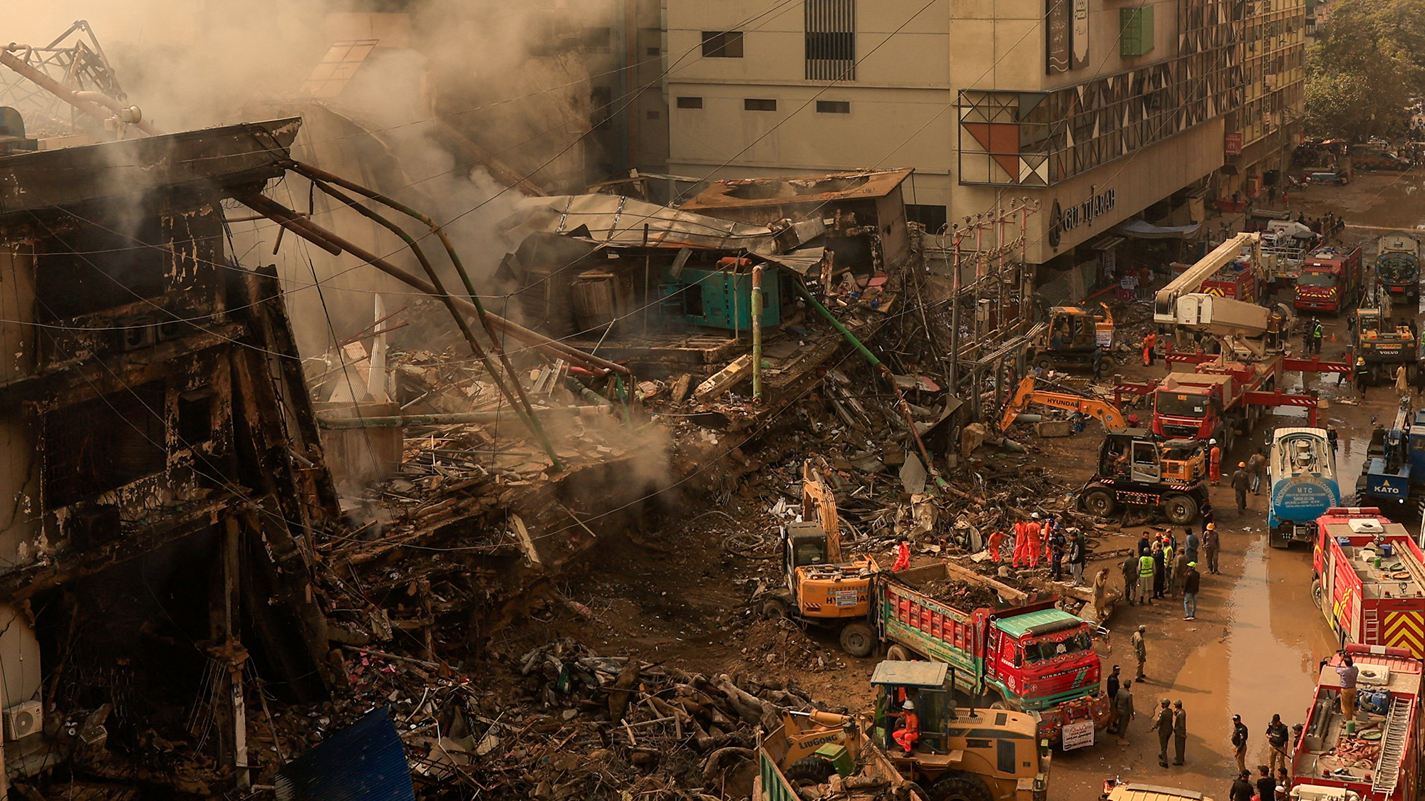 Rescue workers remove rubble following a massive fire that destroyed the Gul Plaza Shopping Mall in Karachi, Pakistan