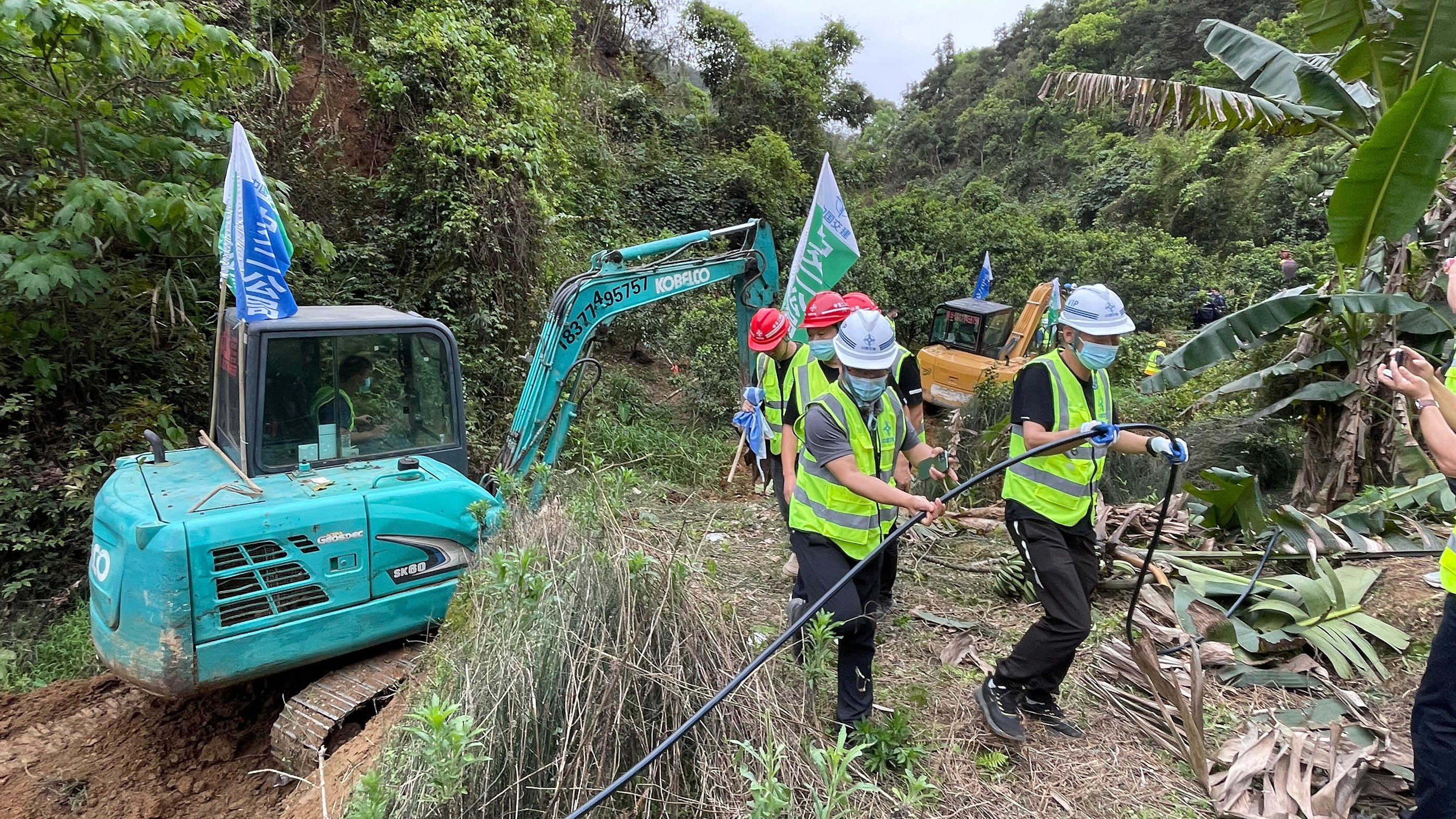 An excavator opening a way to the China Eastern Airlines plane crash site in Tengxian County, south China's Guangxi Zhuang Autonomous Region, March 22, 2022.