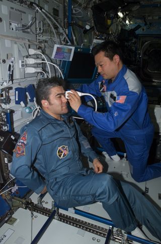 Astronaut Leroy Chiao performs an ultrasound examination of the eye on cosmonaut Salizhan Sharipov aboard the International Space Station. NASA helped turn the station's ultrasound machine into an all-purpose diagnostic imager with a direct line to doctor