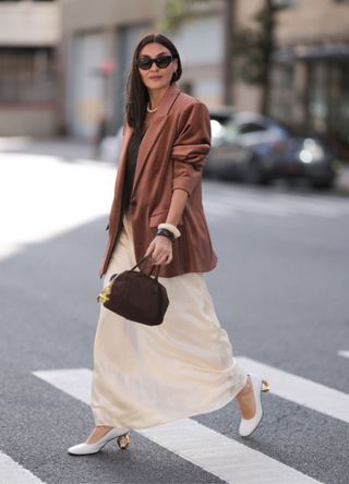 Yana Echko wearing YSL brown sunglasses, Bottega Veneta brown leather bag with a brown cord blazer and a Reformation maxi skirt.