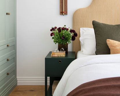 A bed with navy blue nightstand