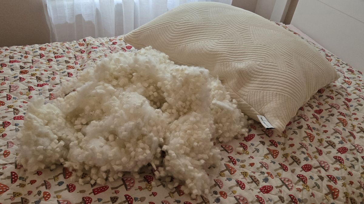 Coop Sleep Goods Adjustable Latex Pillow with nearly one pound of fill removed, placed next to the pillow