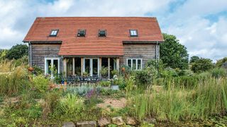 converted barn with well established gardens and hard landscaping areas