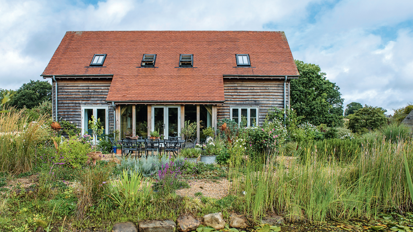 converted barn with well established gardens and hard landscaping areas