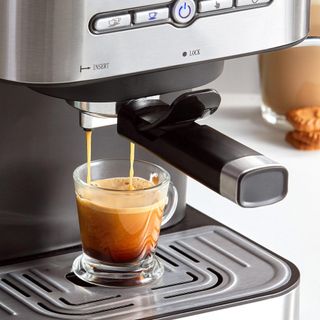 Bean to cup coffee machine making coffee