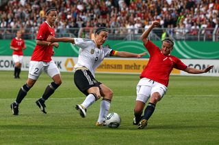 Birgit Prinz (C) of Germany battles for the ball with Trine Roenning (R) of Norway and her team mate Nora Holstad Berge (L) during the women's international friendly match between Germany and Norway at Bruchweg Stadium on June 16, 2011 in Mainz, Germany. (Photo by Alexander Hassenstein/Bongarts/Getty Images)