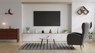 Best 55-inch TVs: Image depicts living room wit 55-inch TV mounted on wall