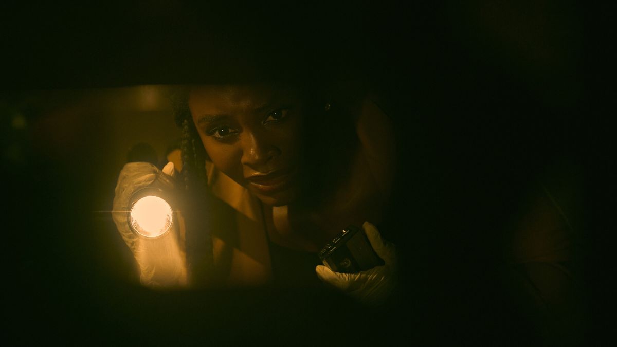 Deborah Ayorinde as Dawn holding a flashlight in THEM: The Scare