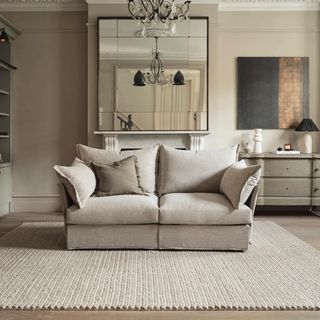 A grey sofa in a neutral living room