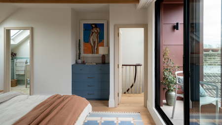 loft conversion master bedroom with a balcony and ensuite toilet attached 