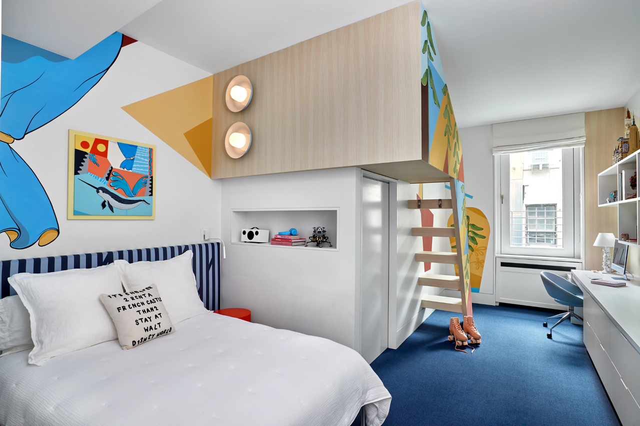 a multifunctional kids room space with artwork on the walls, a bed and a bunk bed with a desk area - the walls are white outside of the artwork and the carpet is a dark blue