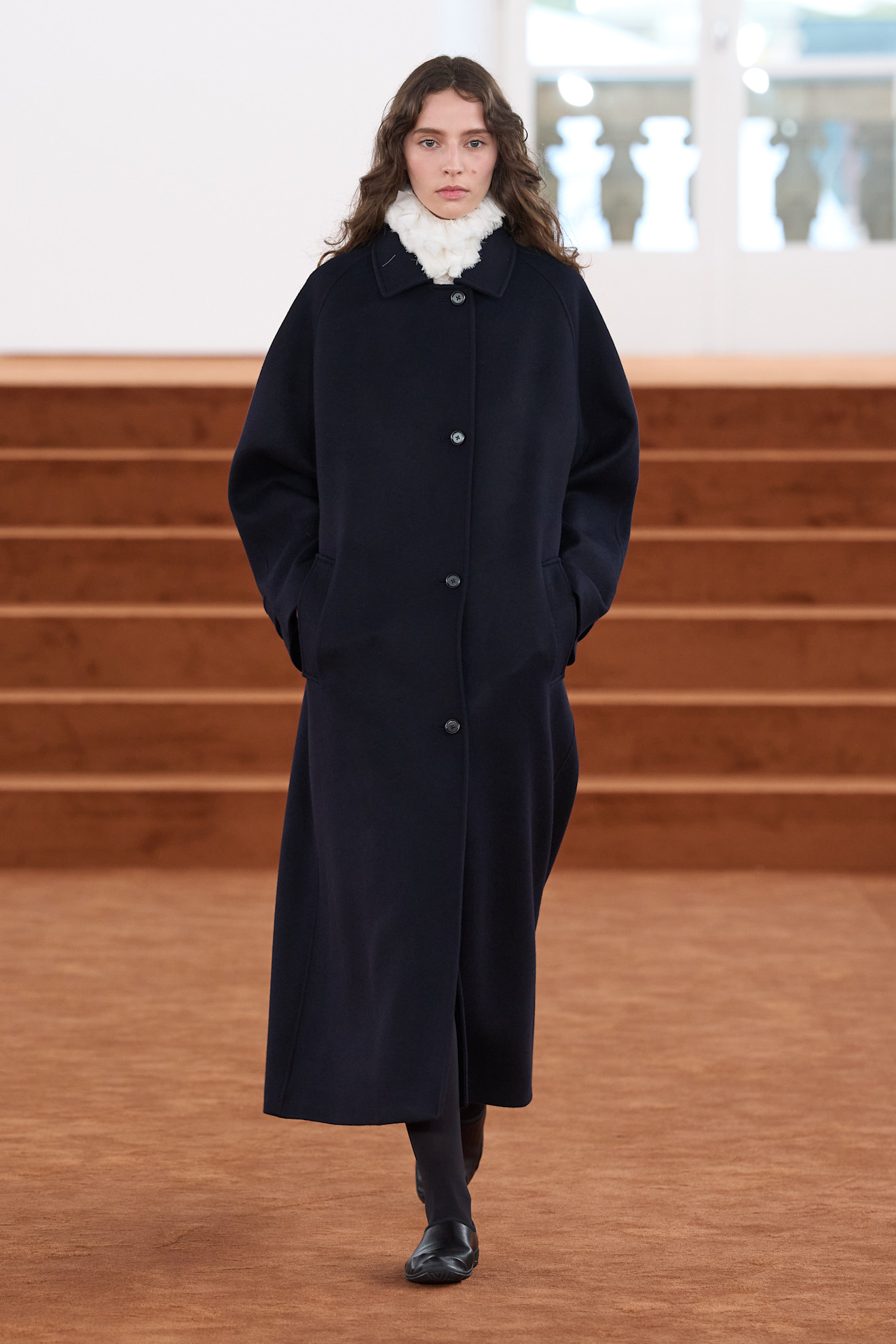 Model wears a frothy collar on the A/W '26