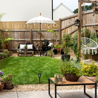 Lawned garden with pergola, outside seating and hanging chair