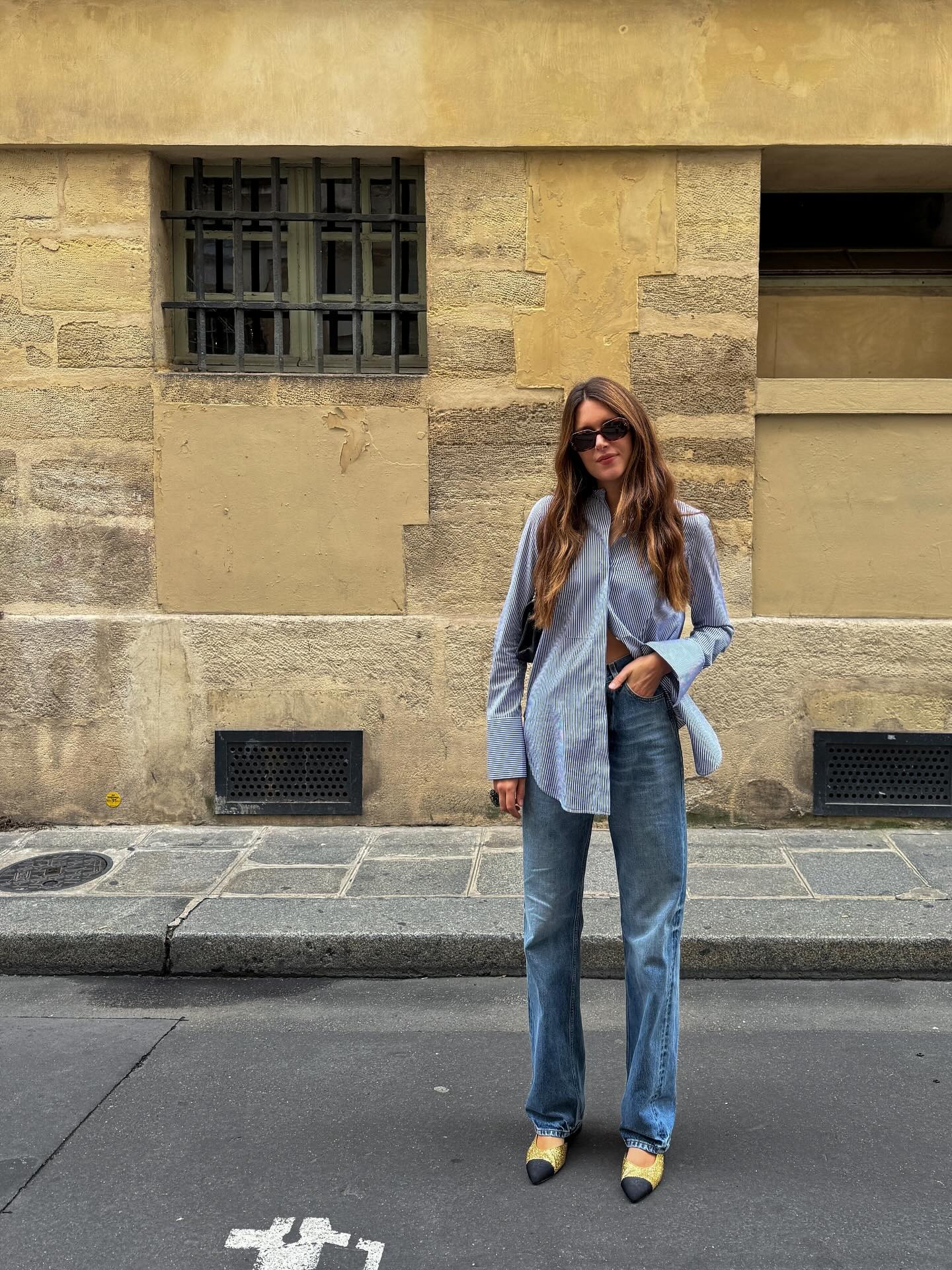 Woman in jeans, shirt and cap-toe shoes