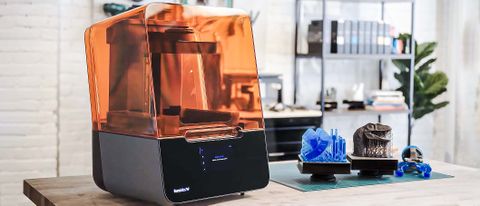 Formlabs Form 3+ 3D printer on desk next to prints