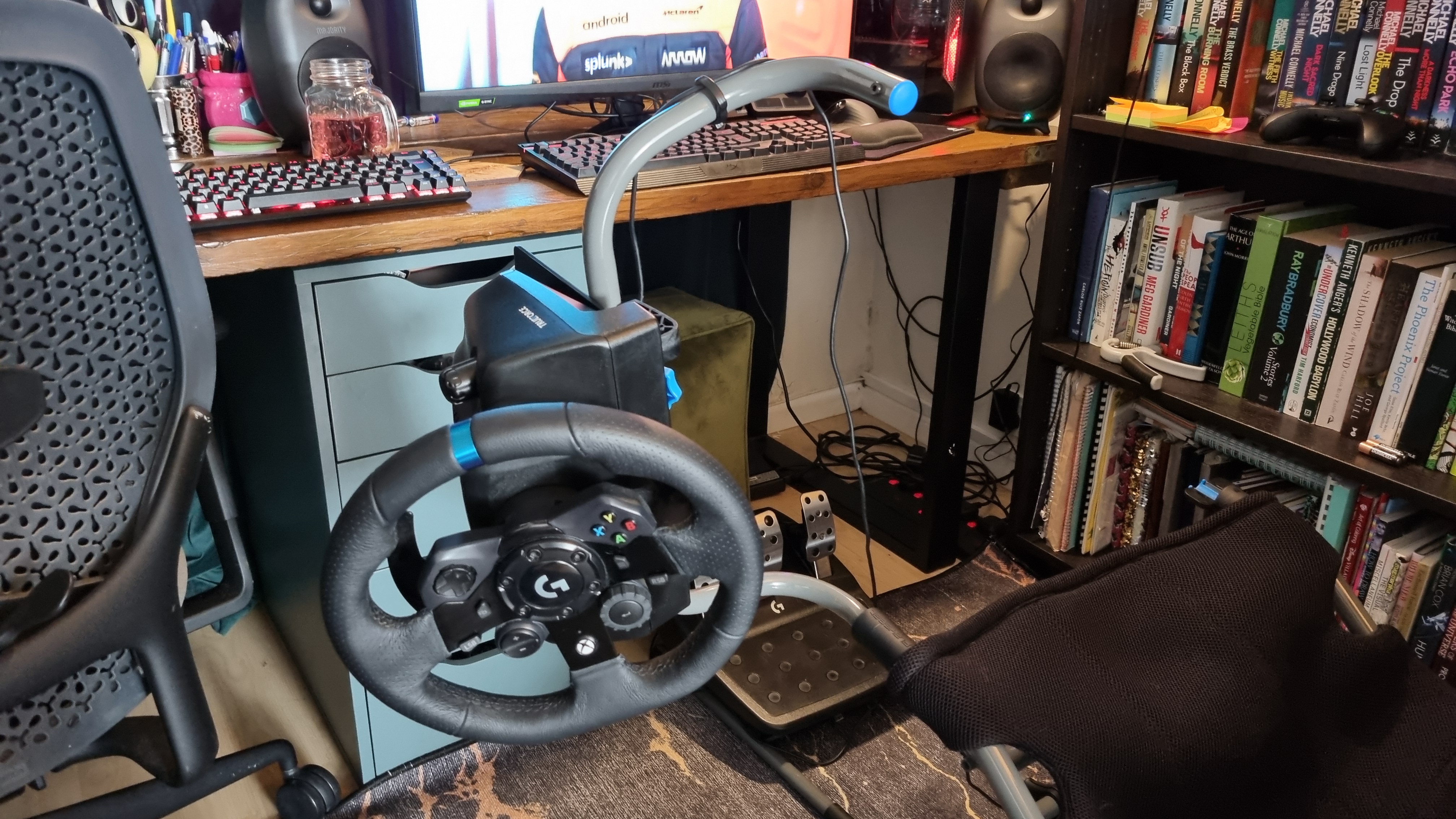 The Logitech Playseat Challenge X with the wheelbase mount open and the Logitech G923 attached
