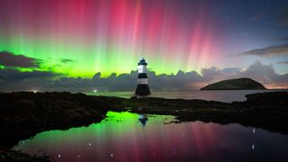 Red and green northern lights over Wales, United Kingdom.