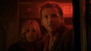 Bradley Cooper and Leslie Bibb bathed in red light on a subway car in The Midnight Meat Train