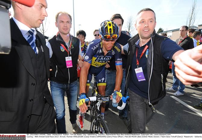 Saxo Bank's Roman Kreuziger is escorted through the press area after winning last year's Amstel Gold